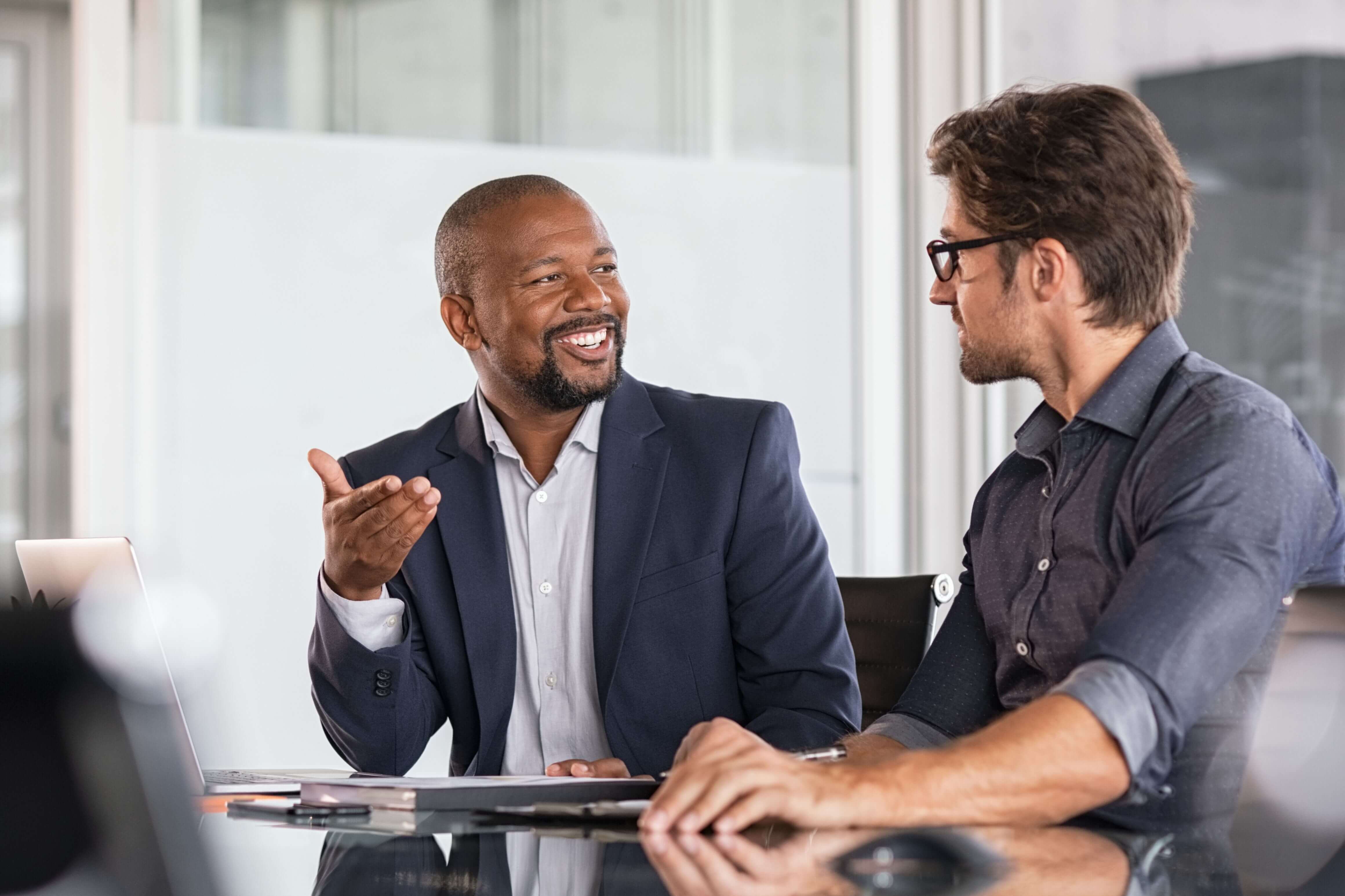 Two professionals in a positive exchange, exemplifying 'Inspiring Feedback™' for a growth-focused, feedback-rich work culture.