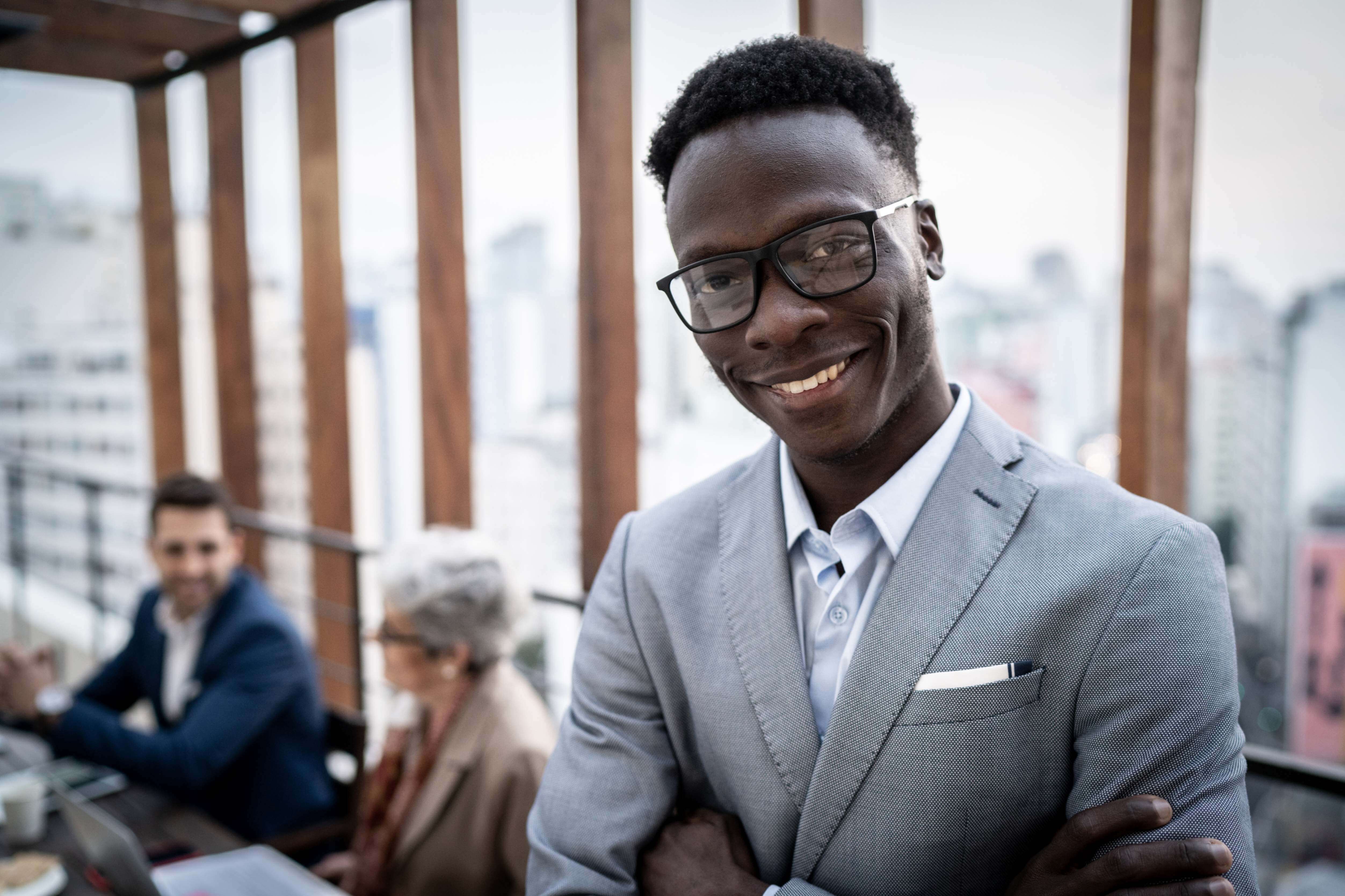 Ethnic corporate executive smiling confidently, embodying 'Leadership Training' for inspirational leaders.