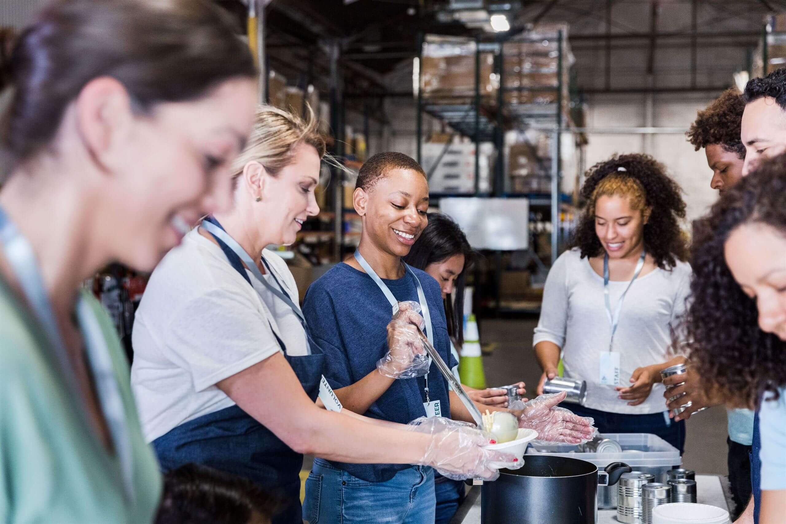 Team members volunteering at a food bank, supporting 'Zero Hunger' efforts in their local community.