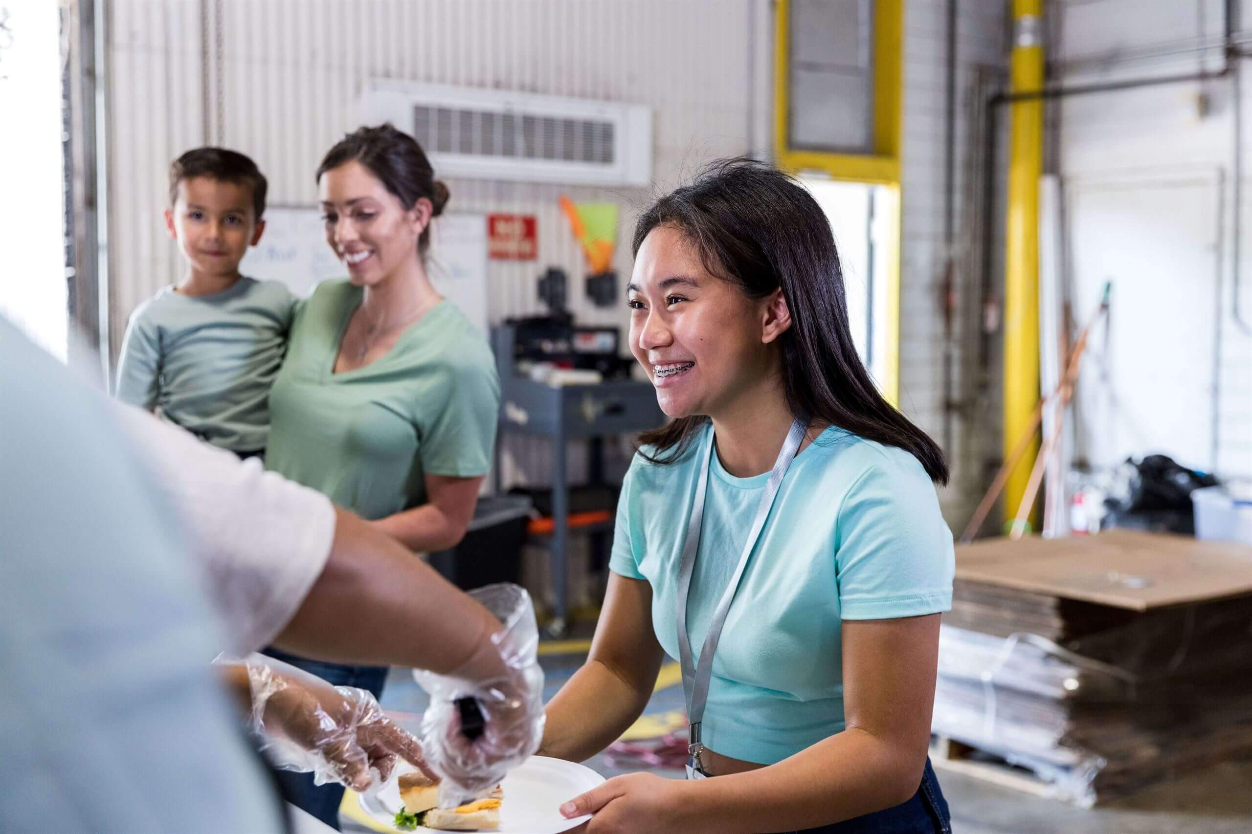 Volunteers from our organization serving food, actively working towards reducing hunger in their community.